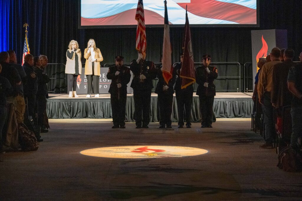 guard with colors and singers on stage